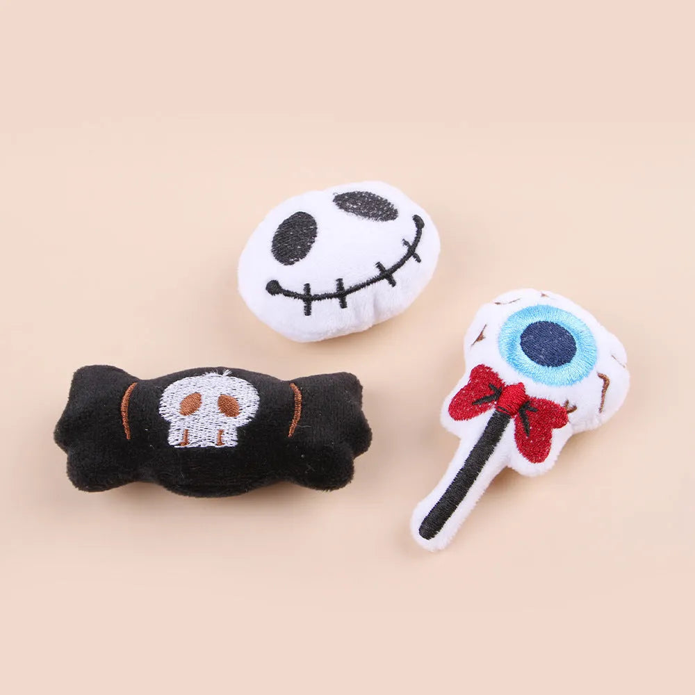 Plush cat wand toy with 27cm handle showing three interchangeable colourful heads: eyes, candy, and skull designs