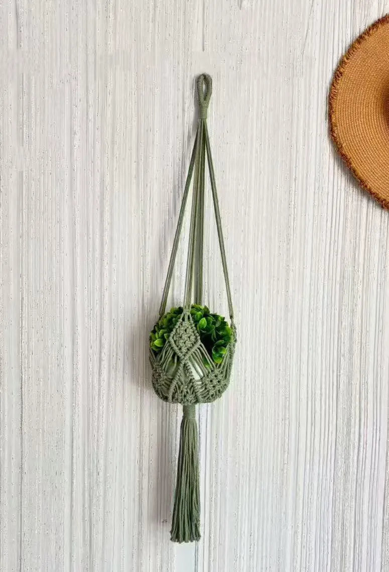 Handwoven brown polyester cotton flower pot net sleeve covering a plant pot.