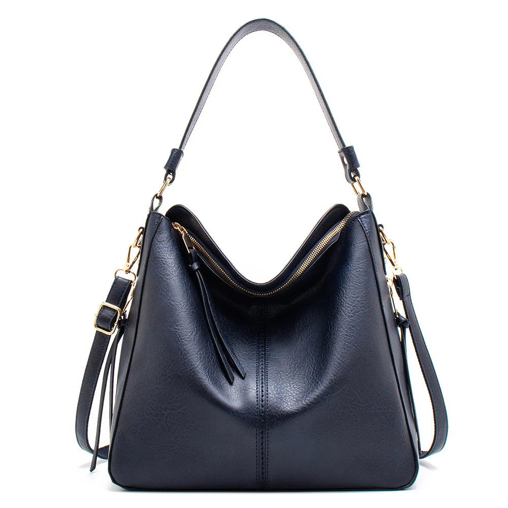 Large capacity PU hobo bag for women with zip closure, internal pockets, and soft handles in solid colour