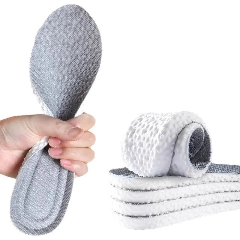 Grey, black, and orange breathable sports insoles made from soft PU material, shown alongside scissors for cut-to-fit sizing.
