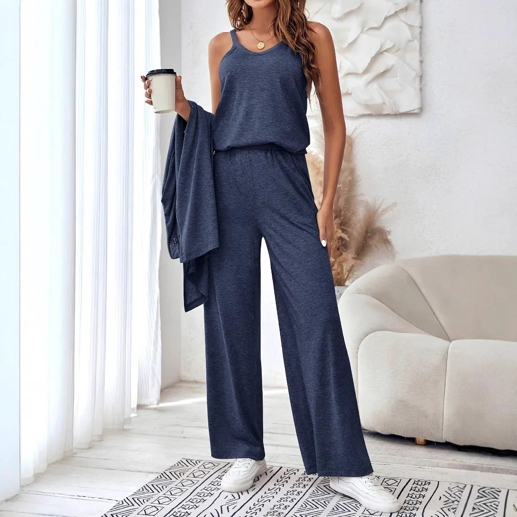 Blue women's polyester suit set with sling top, long cardigan, and trousers on a hanger.
