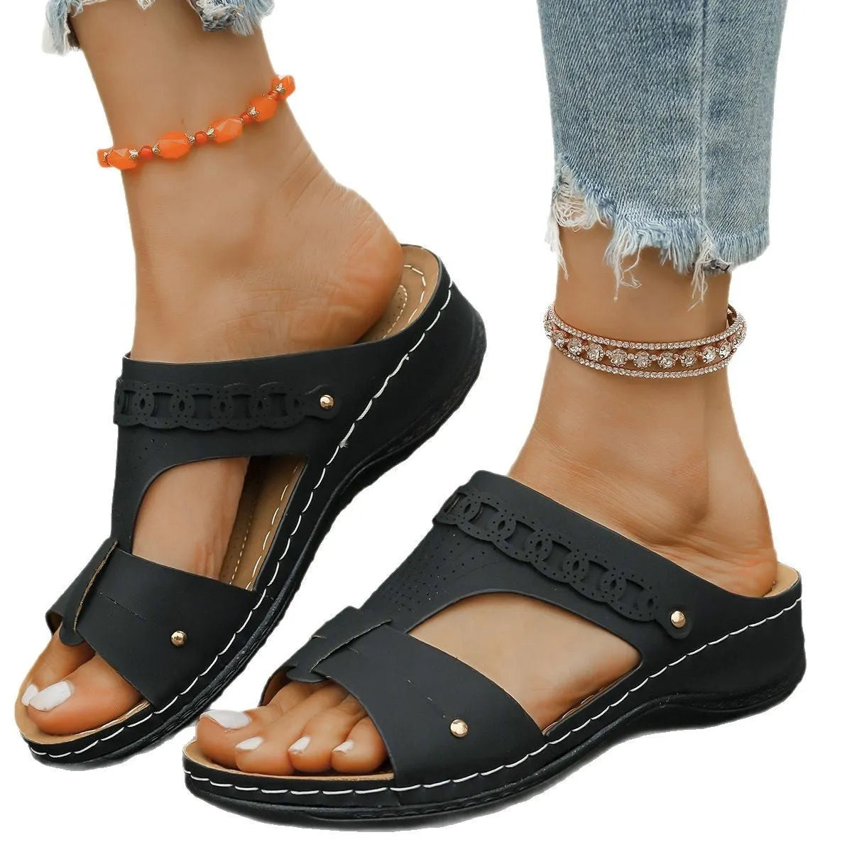 A pair of slope heel Roman style slippers with a fish mouth toe holder, shown in one of six available colours.
