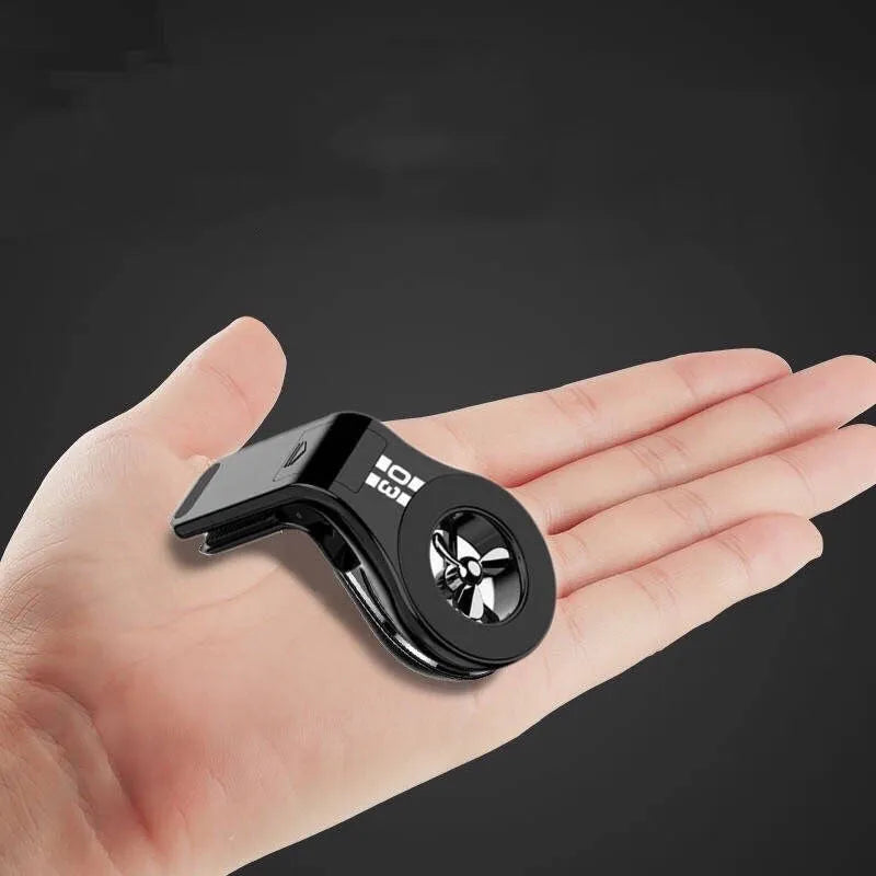 Black magnetic car air vent phone holder with adjustable clip and perfume slice attached