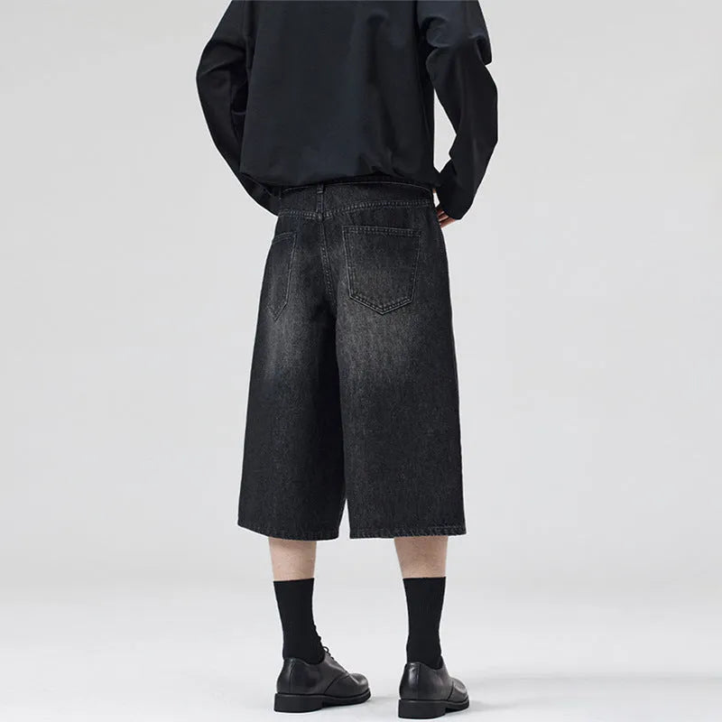 Men's light blue loose-fit cropped denim shorts with a straight leg on a neutral background.