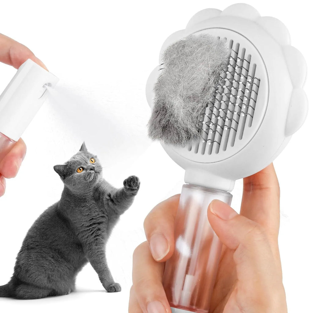 Grey spray cat brush with self-cleaning button and stainless steel bristles on a white background.