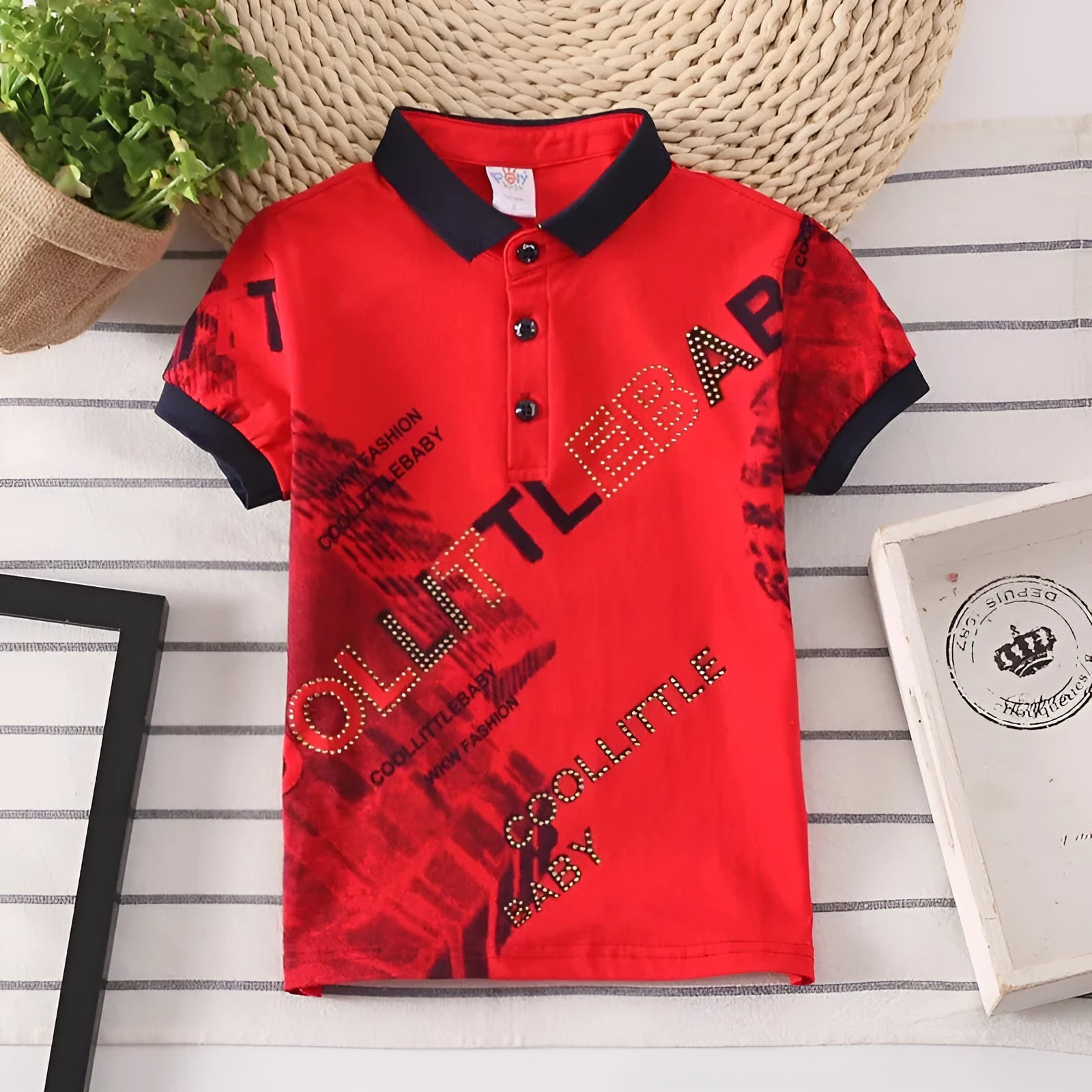 Boys short sleeve cotton T-shirt in navy blue with a lapel collar, laid flat.