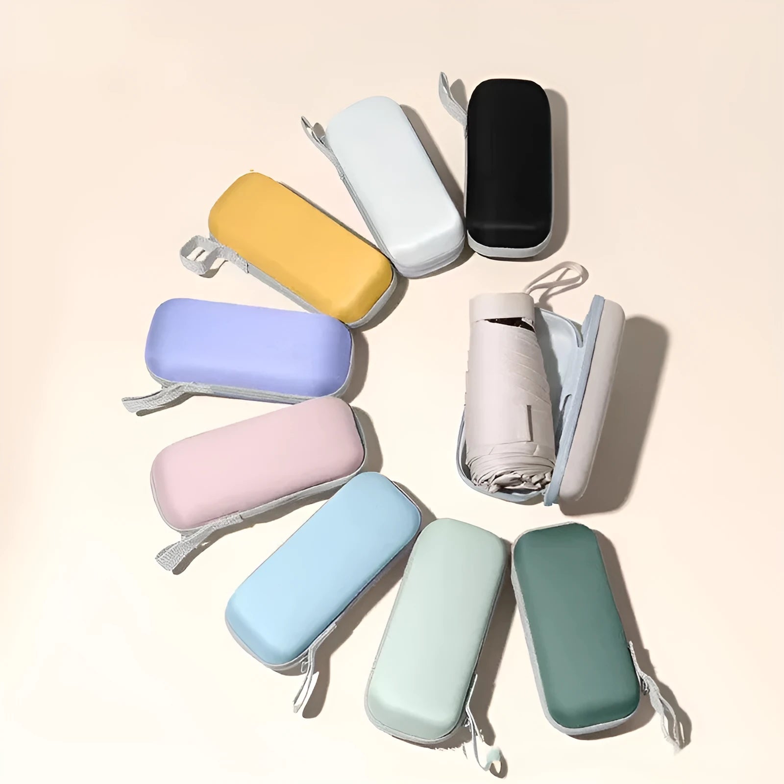 Ultra-light six-fold sun umbrella open, showing NC fabric canopy and rubber handle, next to its compact folded size in a capsule box.