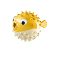 Fish-shaped interactive dog toy with treat dispensing opening and textured surface for medium and large dogs