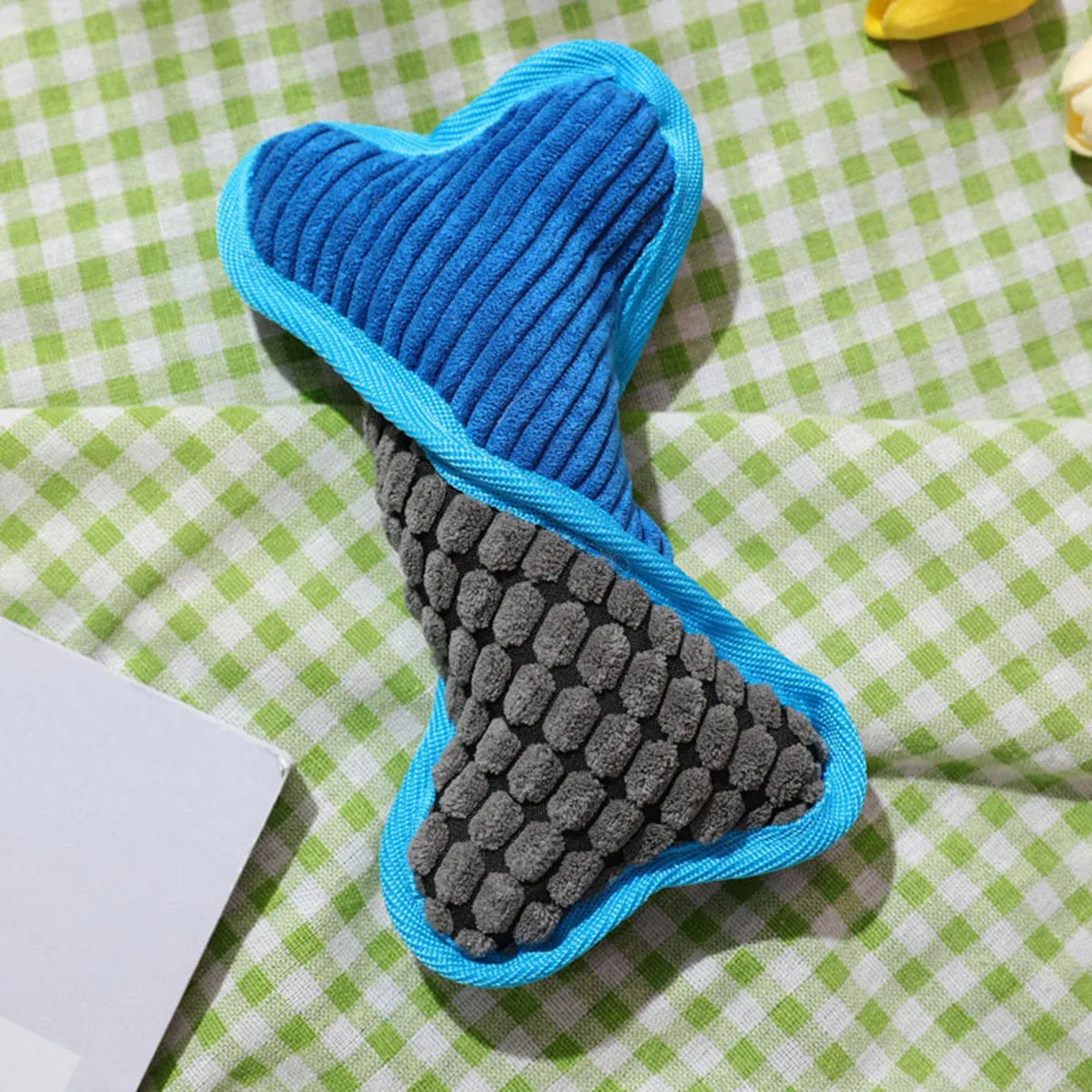 Blue teddy dog toy with a squeaking bone model and corn fleece lining.