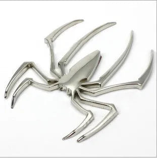 Three-dimensional metal spider sticker in gold colour, measuring 7cm by 5cm.