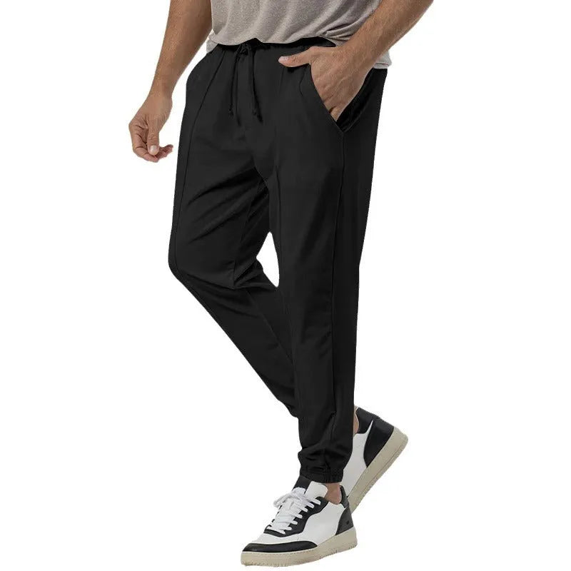 Men's casual track sweatpants in loose tapered straight-leg design showing army green colour option