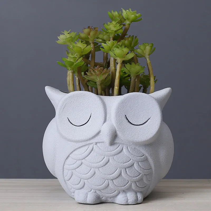 Handmade frosted ceramic flower pot with cartoon owl design, shown in light pink colour.