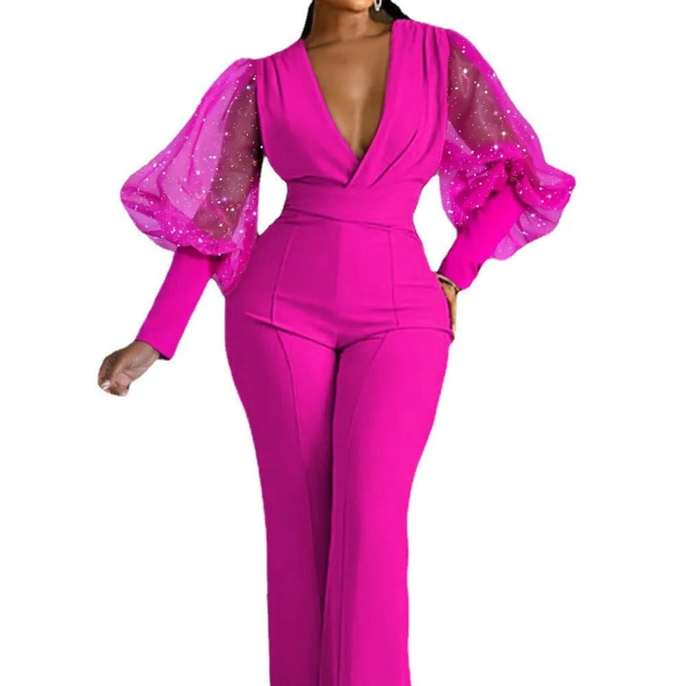 Red long sleeve women's jumpsuit with slim bodice, wide legs, and elasticated waist.