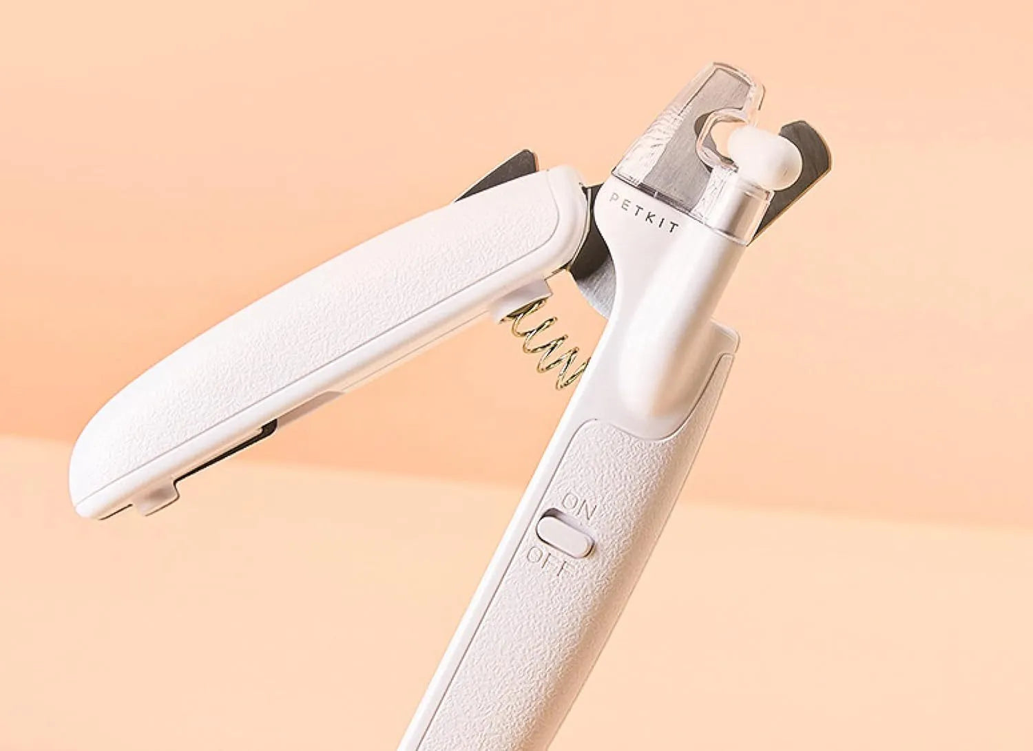 White pet nail clippers with LED light, transparent anti-splash baffle, and a nail file.