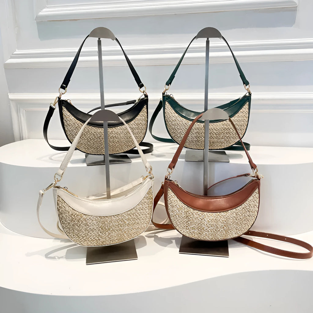 Hard woven straw dumpling-shaped crossbody shoulder bag with organised interior compartments.