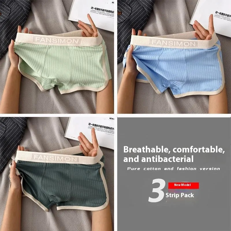 Three-pack of men's milk silk polyester boxer shorts in solid colours on a white background