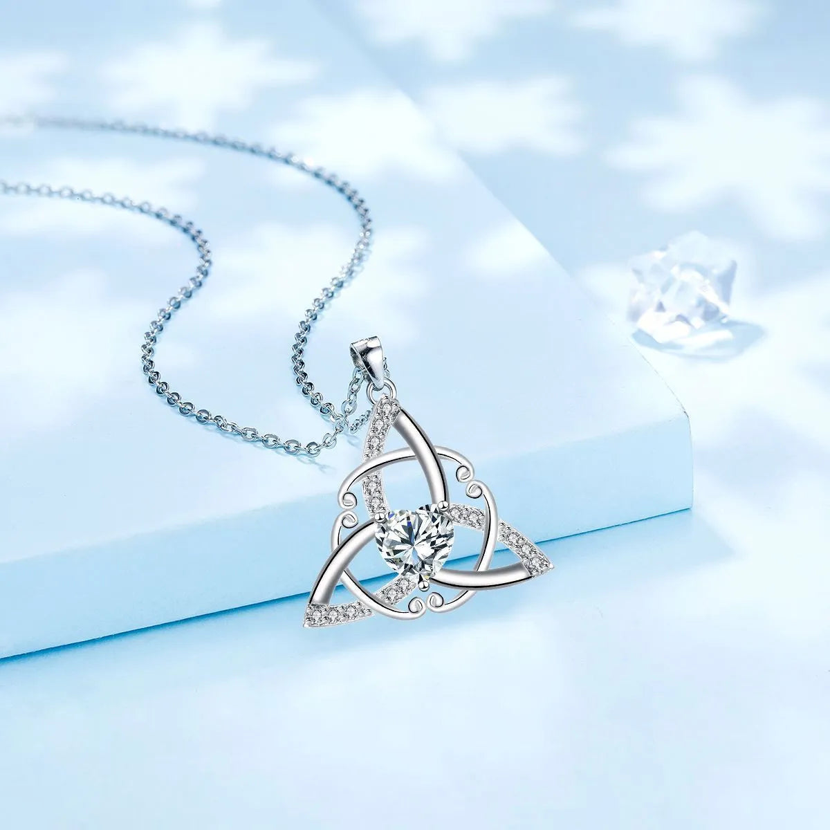 Geometric Celtic knot pendant necklace for women in a choice of blue, lvzuan, red diamond, or white diamond finish.