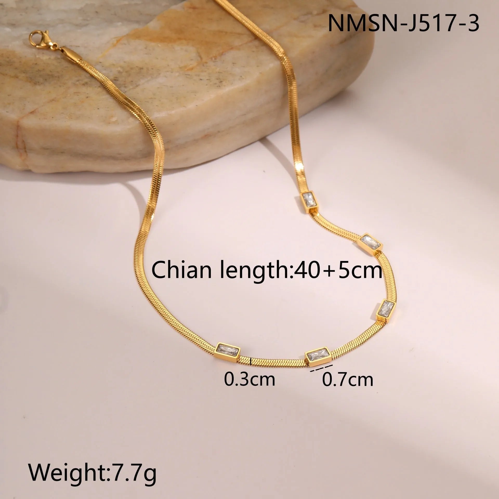 Gold geometric square zircon pendant necklace on a flat stainless steel snake chain.