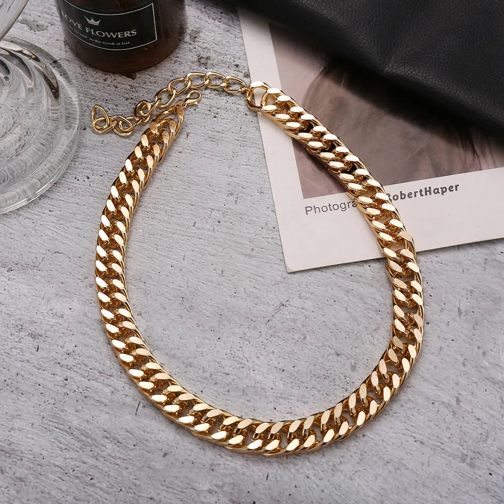Gold-toned women's thick chain necklace with red accents, showing chunky 6cm wide links on a 32cm chain.