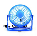 Compact black mini USB desk fan with adjustable tilt, placed next to a laptop.