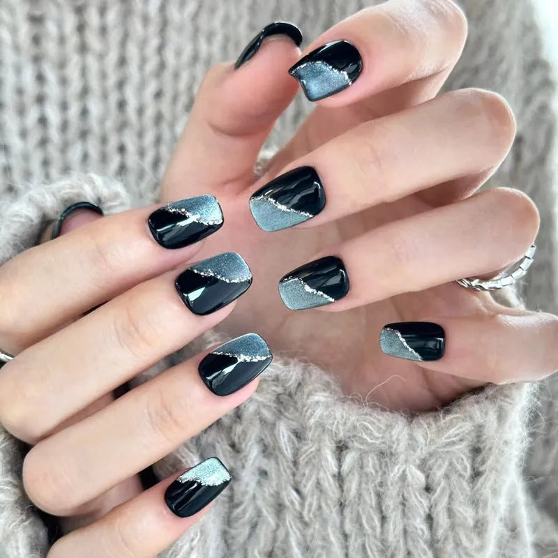 False nails with hand-glued crystal decorations in random mixed colours creating 3D nail art designs