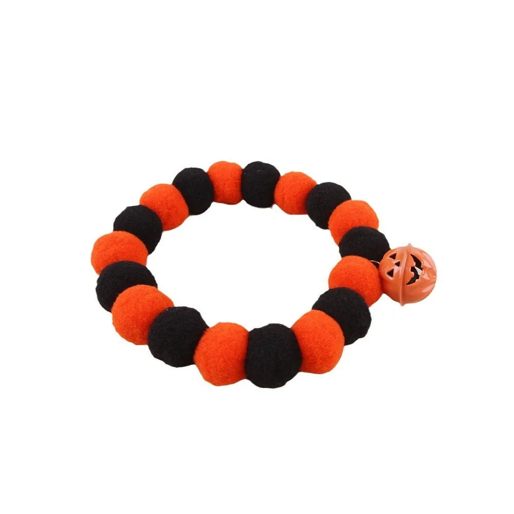 Black and orange Halloween cat collar with a trick or treat pumpkin graphic, shown in small, medium, and large sizes.