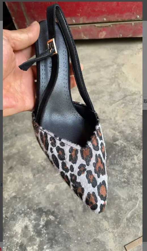 Leopard print suede women's sandals with a pointed toe on a foot mannequin.