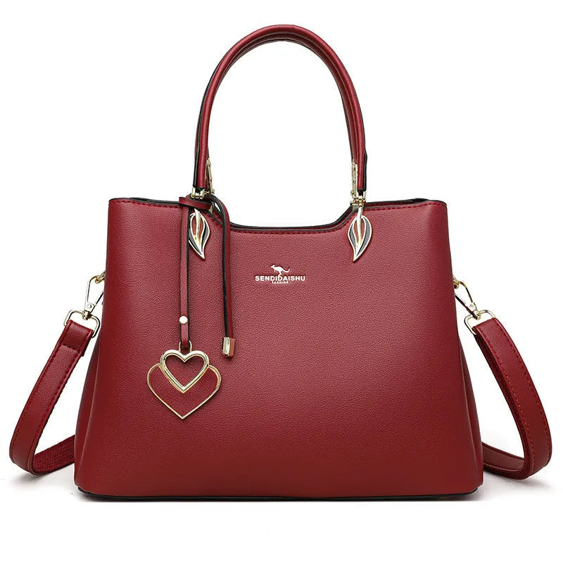 Women's black PU leather shoulder messenger bag with multi-layer compartments and visible stitching details