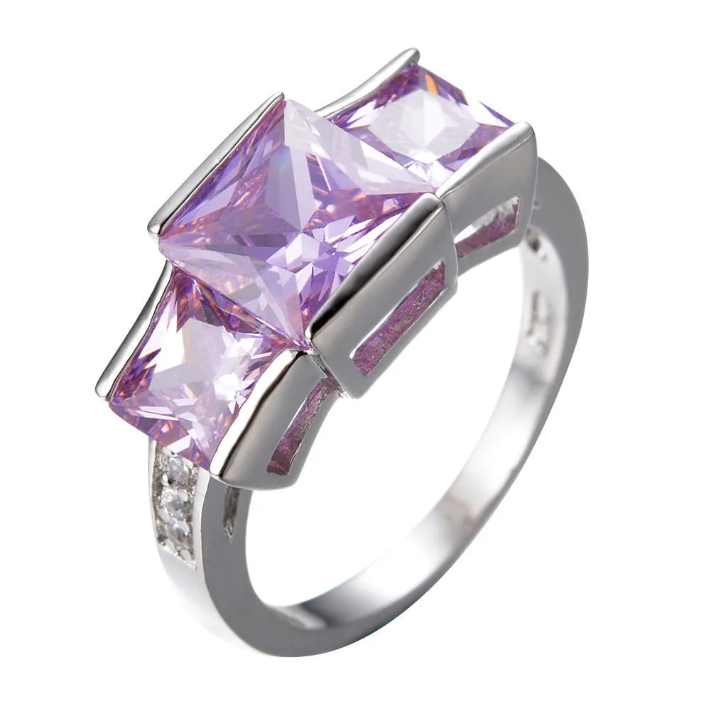 Geometric copper ring for women in champagne colour on a grey background, showing size 8.