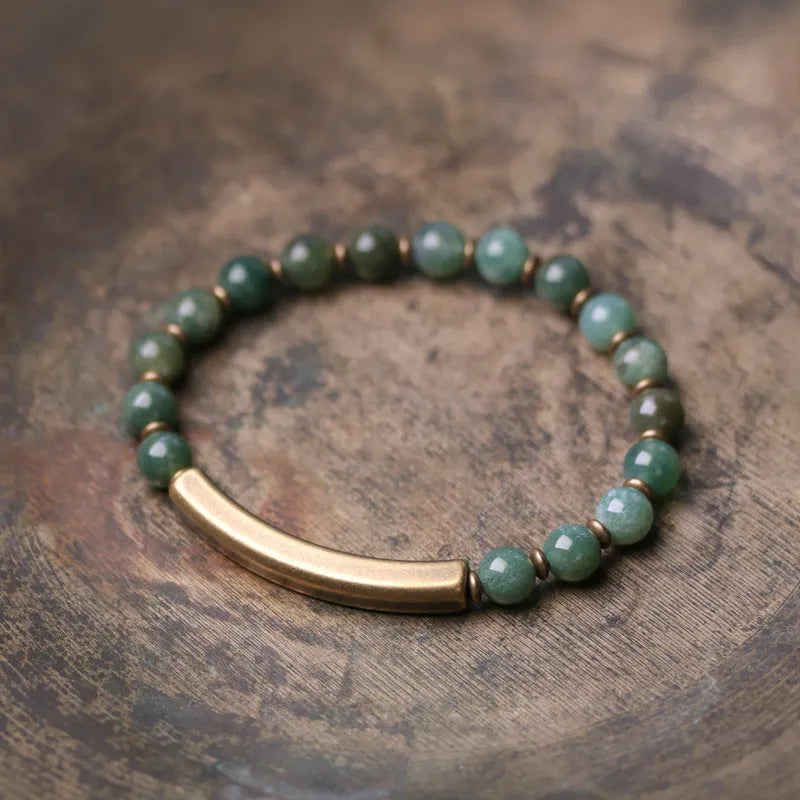 Layered ethnic bracelet with natural agate stones and brass charms on wrist