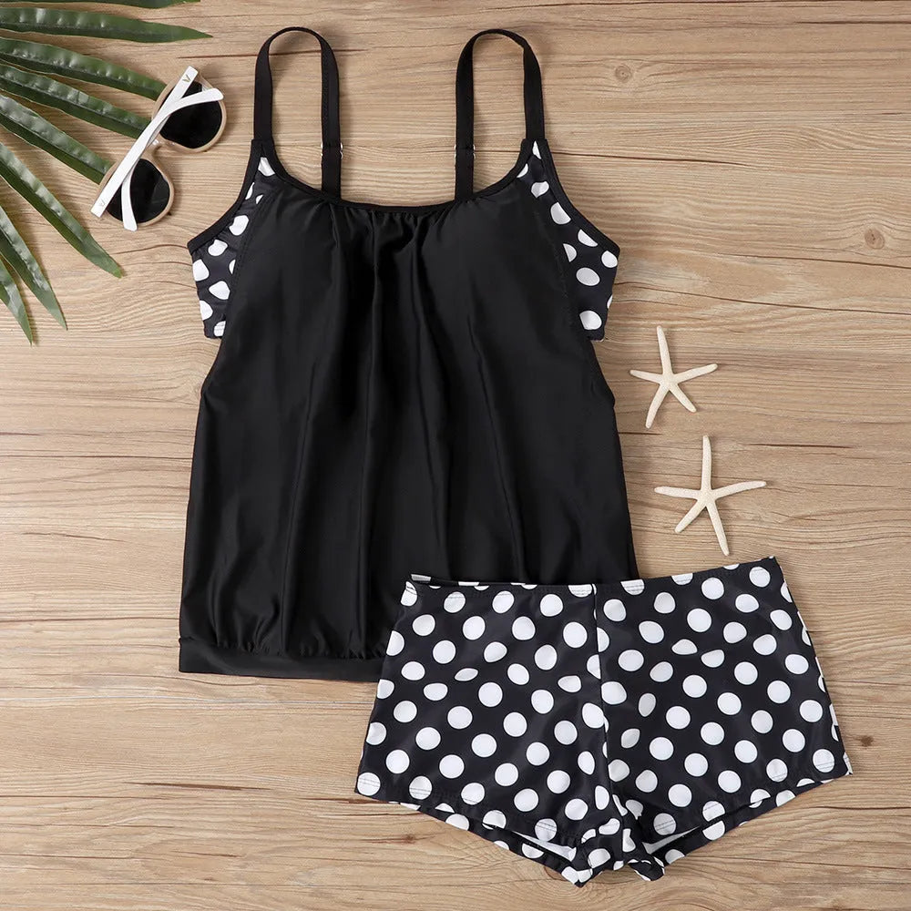 Women's black polka dot boxer swimsuit with high-waisted briefs, made from polyester fabric.