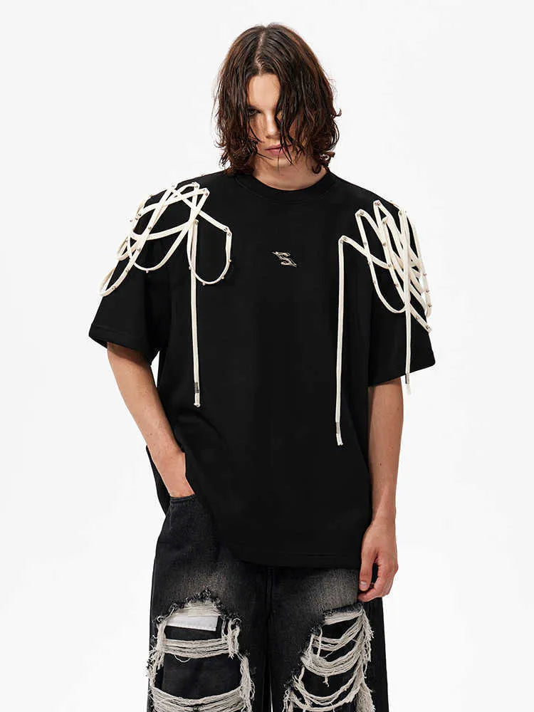 Black loose-fit short-sleeved t-shirt with padded shoulder detail and ribbed cotton texture.