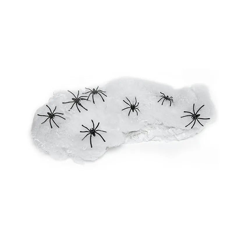 White cotton spider web Halloween decoration with plastic spiders for party or haunted house atmosphere