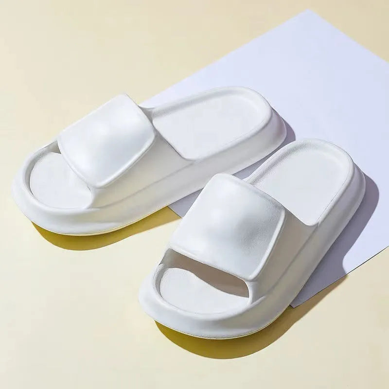 Pair of thick-soled EVA flip flop slippers in purple, showing deep sole profile.