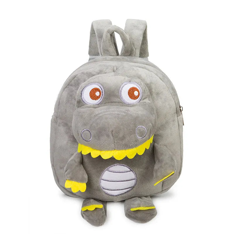 Soft blue plush dinosaur backpack for kids with embroidered character detail and a soft handle.