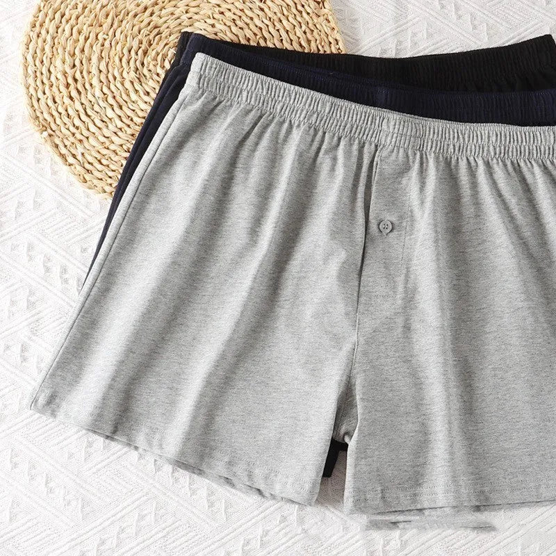 Men's solid-colour cotton boxer shorts with a high-waist, loose fit on a neutral background.