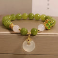 Natural stone green tourmaline women's bracelet with four-leaf clover charm and safety buckle closure