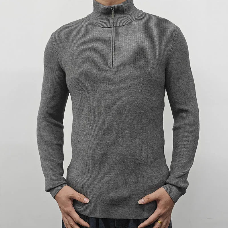 Man wearing a grey half-turtleneck zipper sweater, a cotton blend pullover for casual wear.