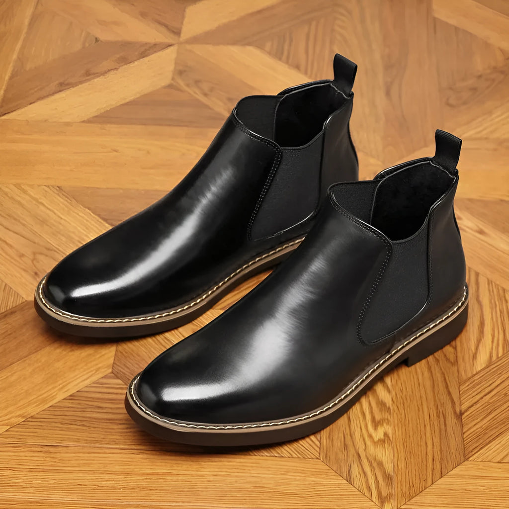 Black and brown formal men's pointed-toe leather boots with a square rubber heel.