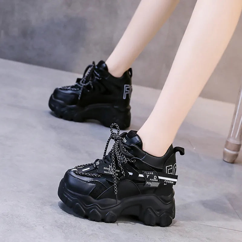 Women's white and black mesh platform sports shoes with cross-strap and rubber sole.