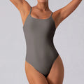 Slim sleeveless yoga jumpsuit for women in light blue, shown in a yoga pose.