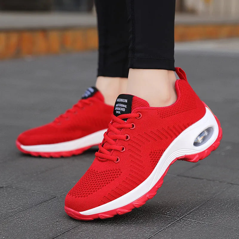 Women's red and black mesh sneakers with lace-up front and round toe design