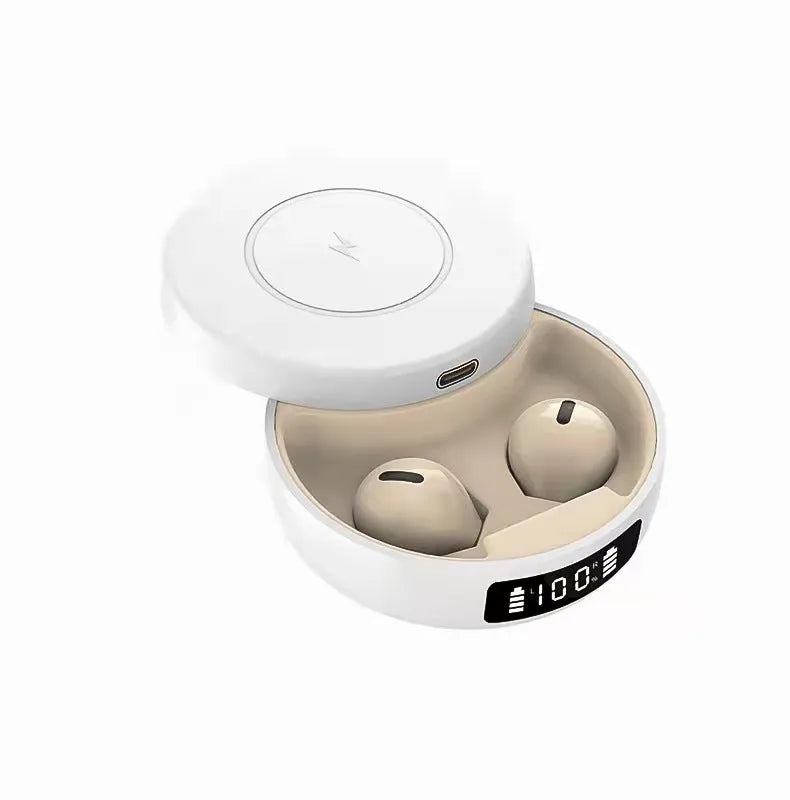 Mini black semi-in-ear wireless headphones sitting inside their white wireless charging case.