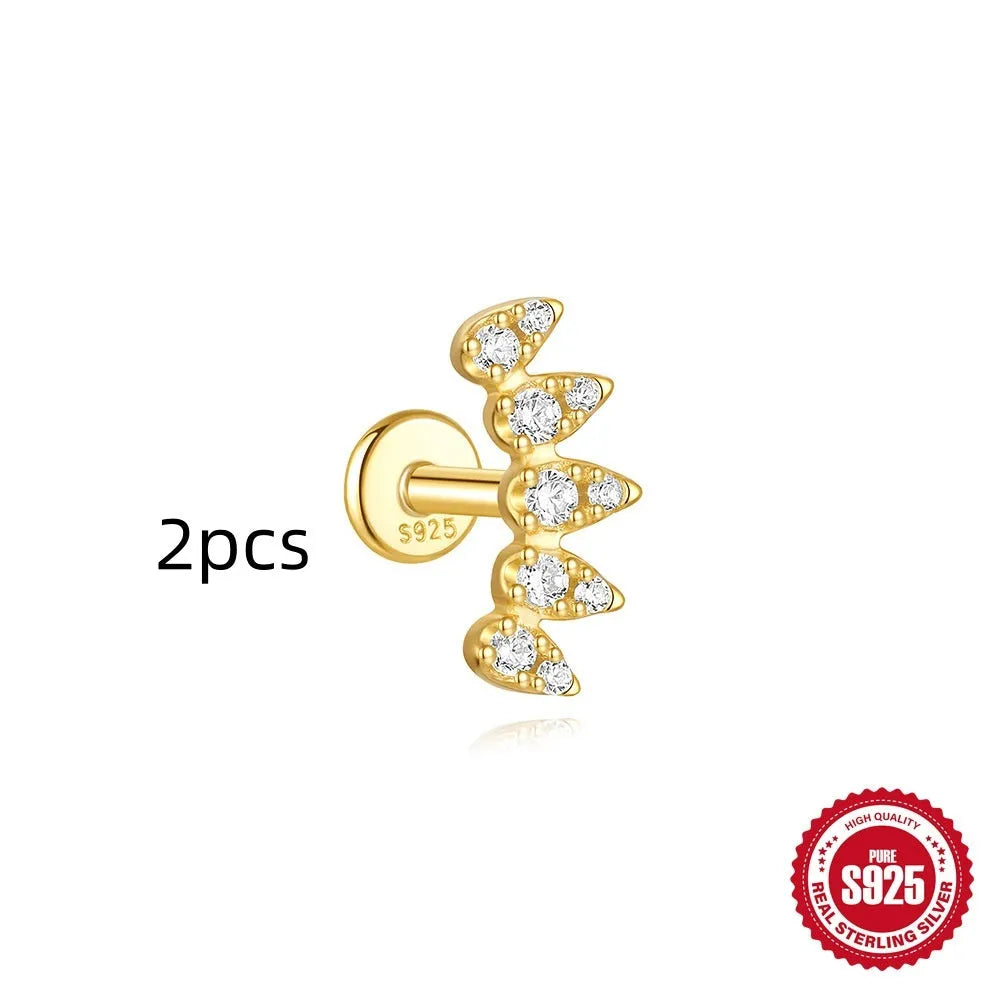 Geometric kite-shaped sterling silver earring with rhinestone head and gold chain tassel.