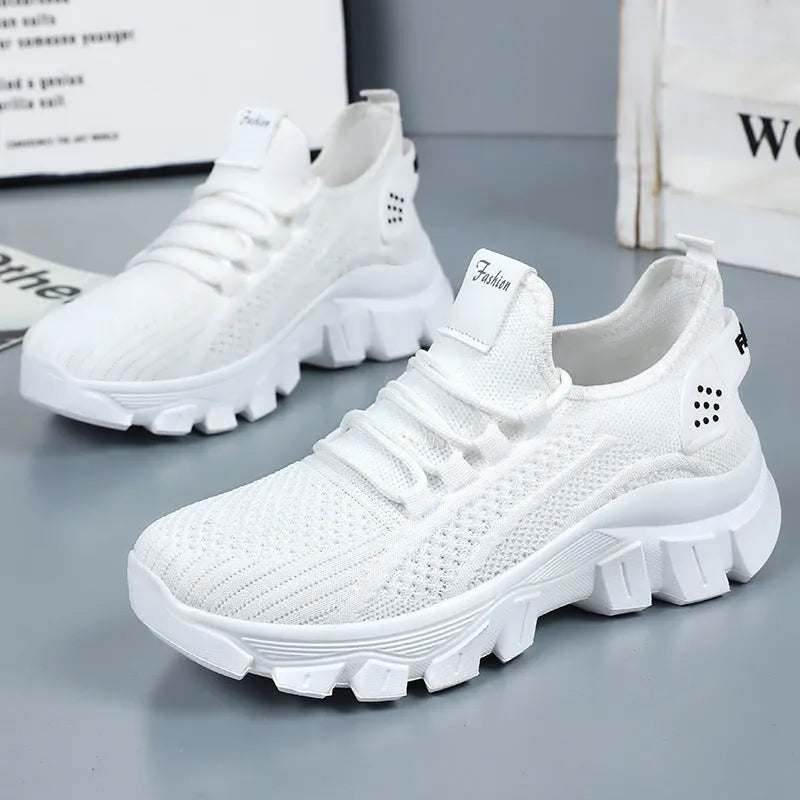 Women's white Flyknit running sneakers with thick PVC sole and lace-up front