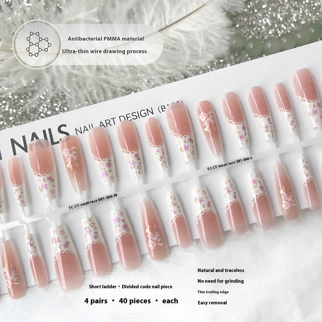 Set of 40 small floral prefabricated nail tips with long ladder velvet seal layer in white, displayed on a flat surface