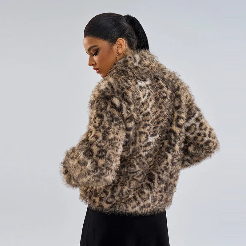 Women's leopard print coat with a buckle lapel fastening, shown in street fashion style.