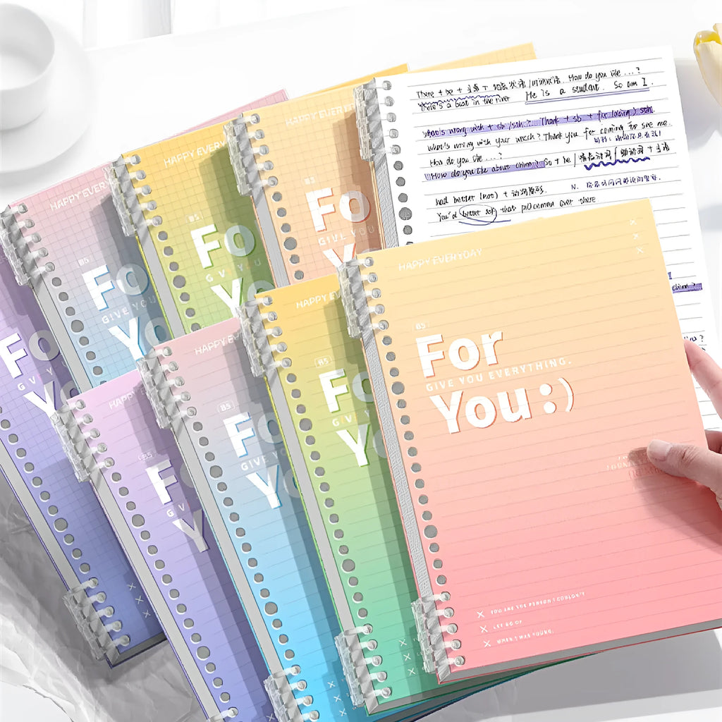 Removable coil notebook with gradient colour cover in blue, showing spiral binding and wood-free paper pages.