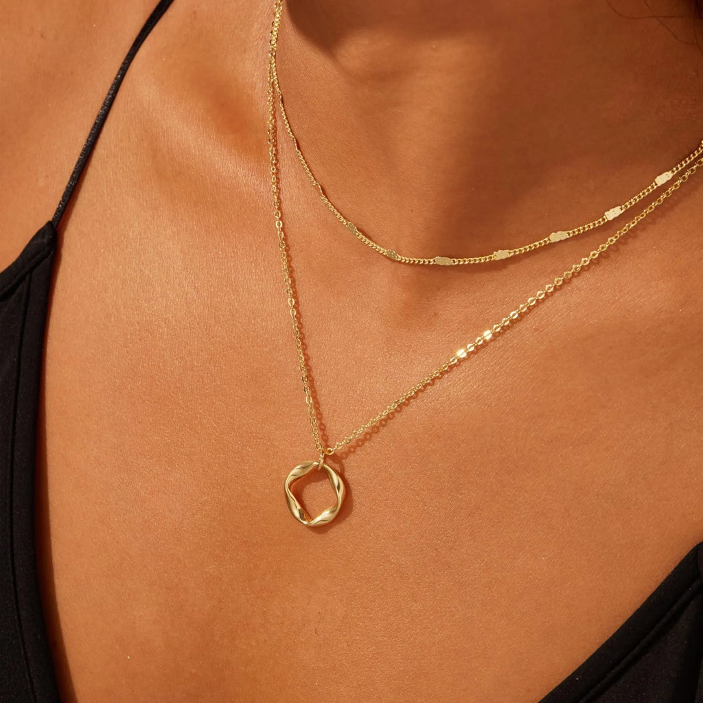 Copper electroplated layered clip necklace with circle pendant in gold finish