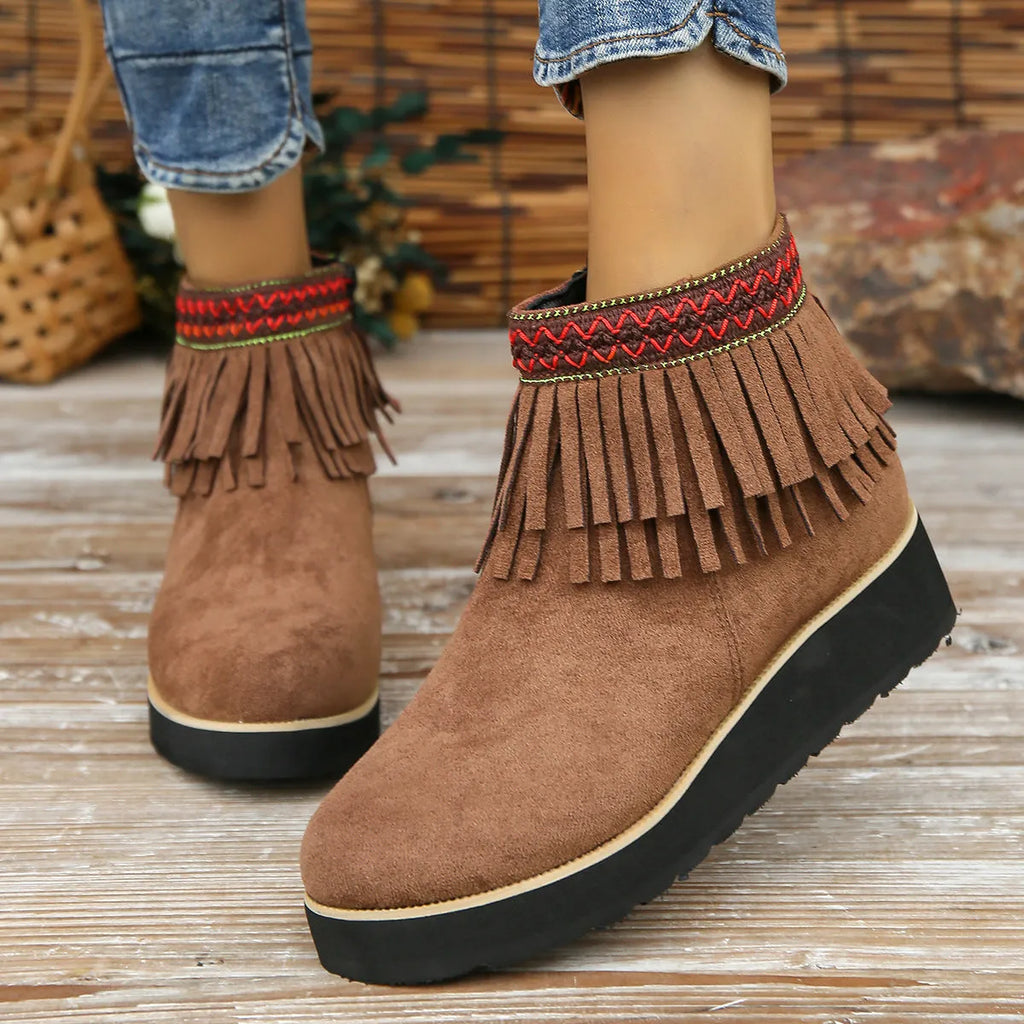 Women's dark brown suede wedge ankle boot with side zip, tassel, and thick rubber sole.